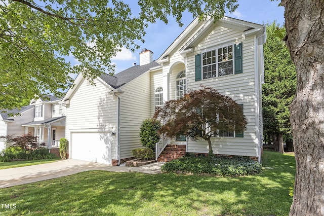 traditional home with driveway, a garage, a front yard, and a chimney