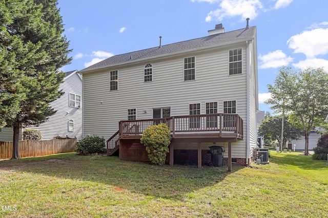 back of property featuring central air condition unit, a wooden deck, and a chimney