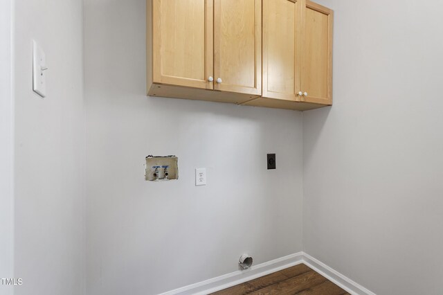washroom featuring washer hookup, electric dryer hookup, cabinet space, baseboards, and dark wood-style floors
