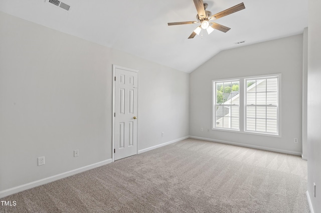 unfurnished room featuring carpet flooring, vaulted ceiling, ceiling fan, and baseboards