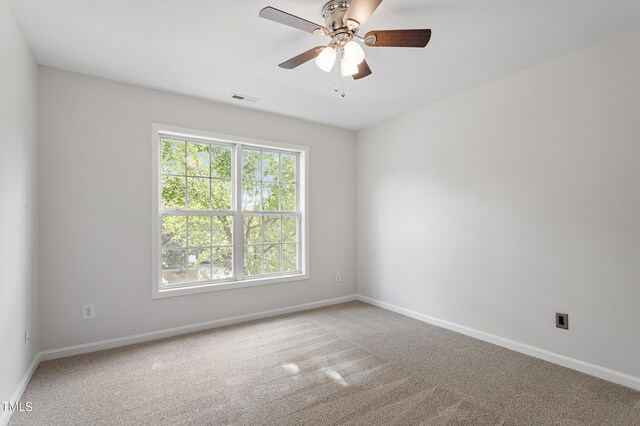 unfurnished room with baseboards, carpet, and a ceiling fan