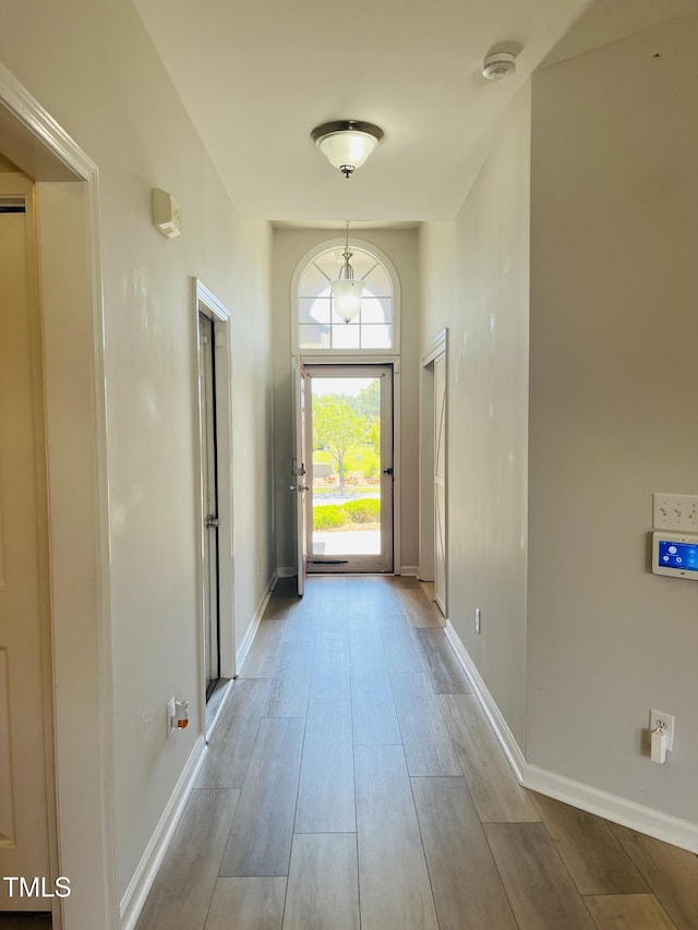 entryway featuring wood finished floors and baseboards