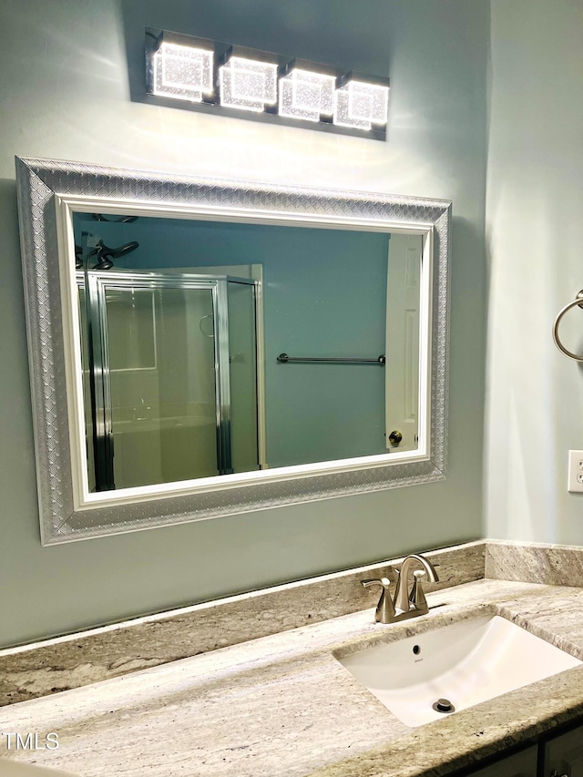 full bathroom with vanity and an enclosed shower