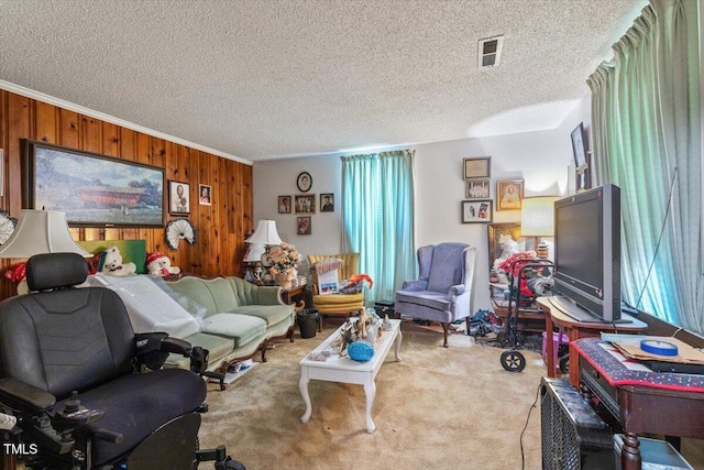carpeted living area featuring wood walls, crown molding, and a textured ceiling