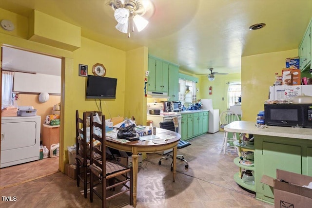 dining area with washer / clothes dryer and a ceiling fan
