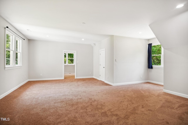 spare room featuring light carpet, healthy amount of natural light, baseboards, and recessed lighting