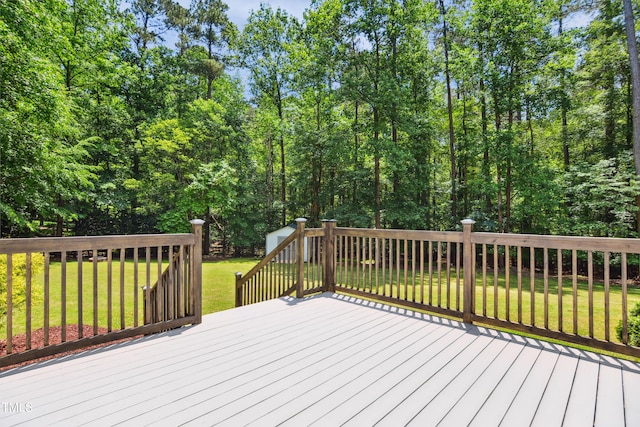 wooden terrace with a lawn