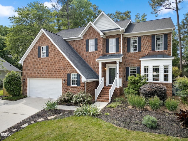 6 Beltre Ct, Durham, NC 27705 - colonial home with concrete driveway, brick siding, and roof with shingles