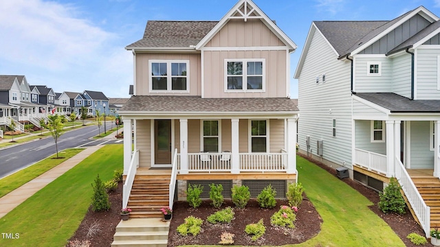 825 Abbyberry Dr, Wake Forest, NC 27587 - view of front of house with a porch, stairway, board and batten siding, a residential view, and a front yard