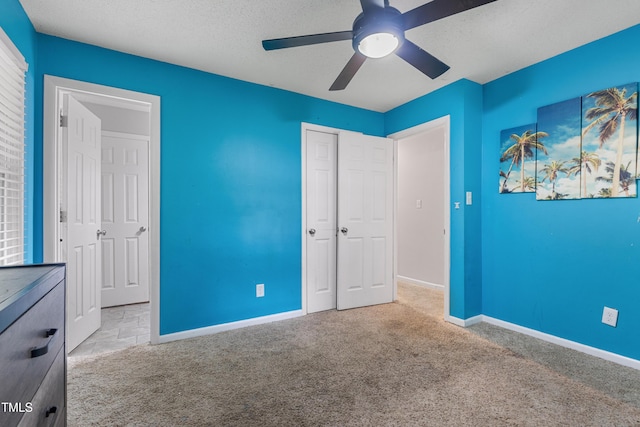 901 Currin Perry Rd, Zebulon, NC 27597 - unfurnished bedroom featuring carpet floors, baseboards, a closet, a ceiling fan, and a textured ceiling