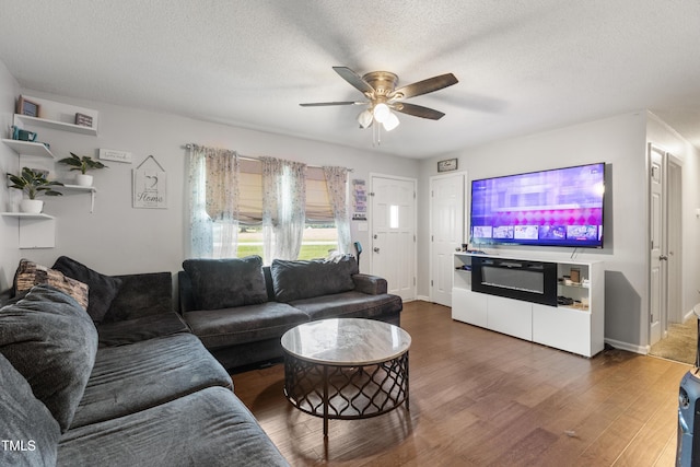 901 Currin Perry Rd, Zebulon, NC 27597 - living room with wood finished floors, ceiling fan, a textured ceiling, and baseboards