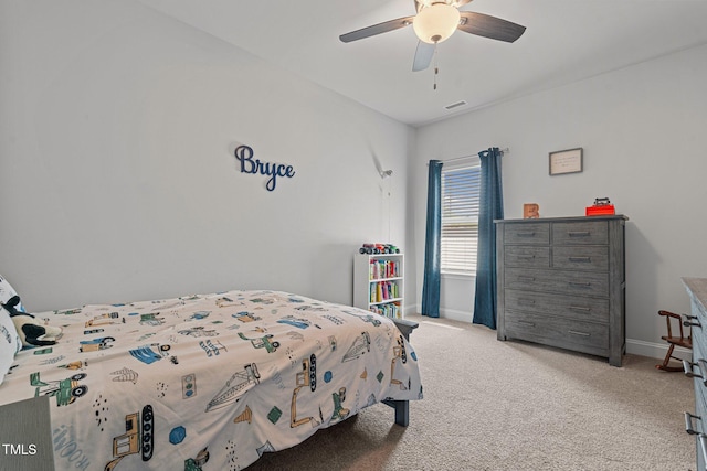carpeted bedroom featuring baseboards and ceiling fan