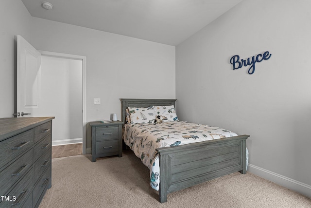 bedroom featuring carpet flooring and baseboards