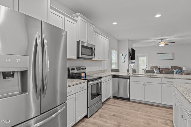 kitchen featuring appliances with stainless steel finishes, a sink, recessed lighting, ceiling fan, and white cabinetry