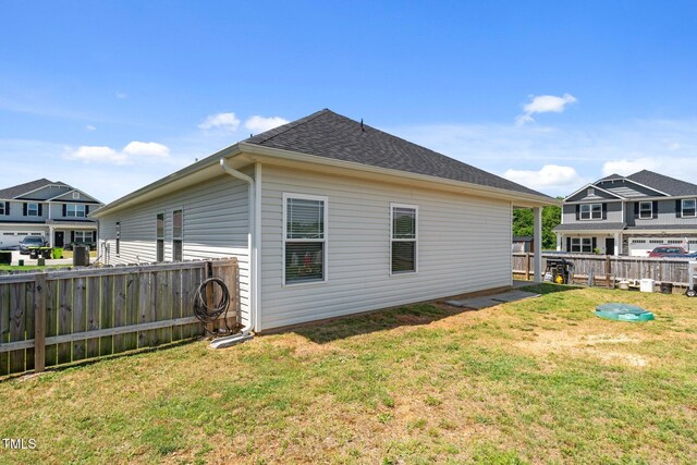 back of property with a shingled roof