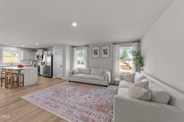 living room featuring light wood-style flooring and recessed lighting