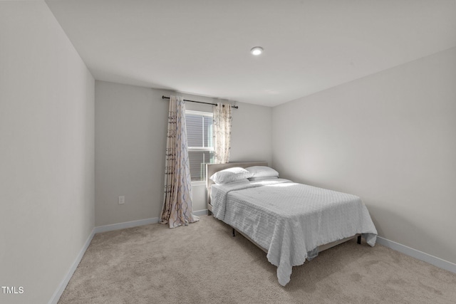 carpeted bedroom featuring baseboards