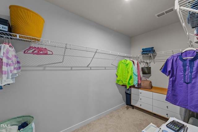 walk in closet with carpet flooring
