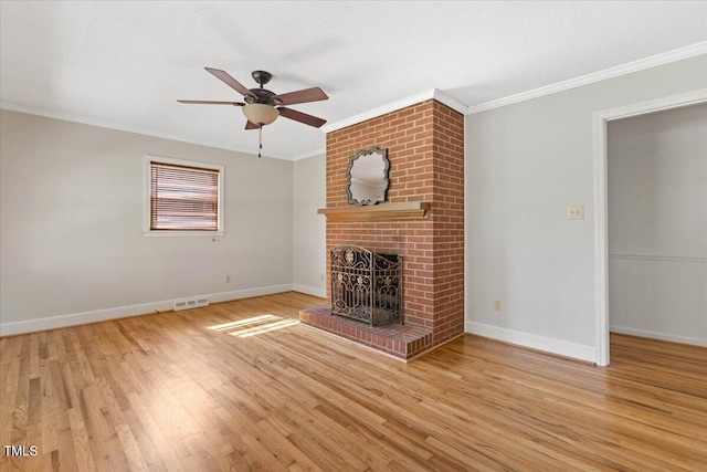 unfurnished living room featuring crown molding, a fireplace, a ceiling fan, wood finished floors, and baseboards