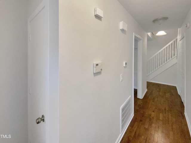 hall featuring wood-type flooring and stairway