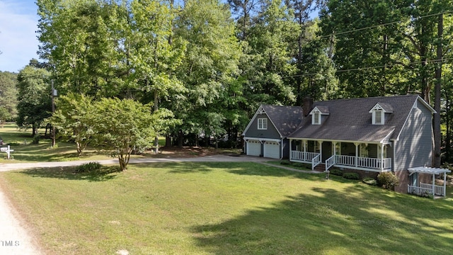 6517 Hidden Pond Rd, Wendell, NC 27591 - view of front of home with a porch, driveway, a front lawn, a chimney, and a garage