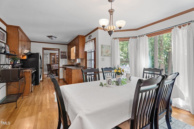 6517 Hidden Pond Rd, Wendell, NC 27591 - dining room featuring light wood-type flooring, crown molding, and a chandelier
