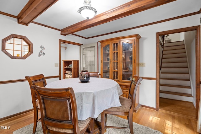 6517 Hidden Pond Rd, Wendell, NC 27591 - dining area with beam ceiling, stairs, light wood-style floors, and baseboards