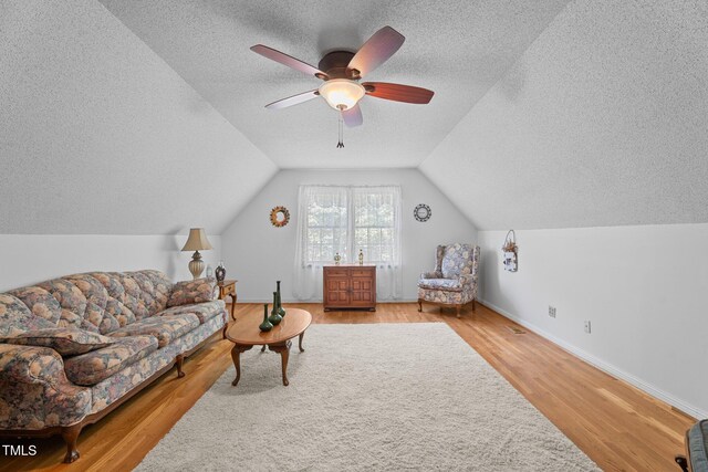 6517 Hidden Pond Rd, Wendell, NC 27591 - living room with a textured ceiling, a ceiling fan, vaulted ceiling, wood finished floors, and baseboards