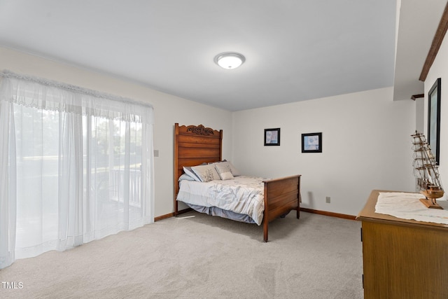 6517 Hidden Pond Rd, Wendell, NC 27591 - bedroom with light colored carpet, access to exterior, and baseboards