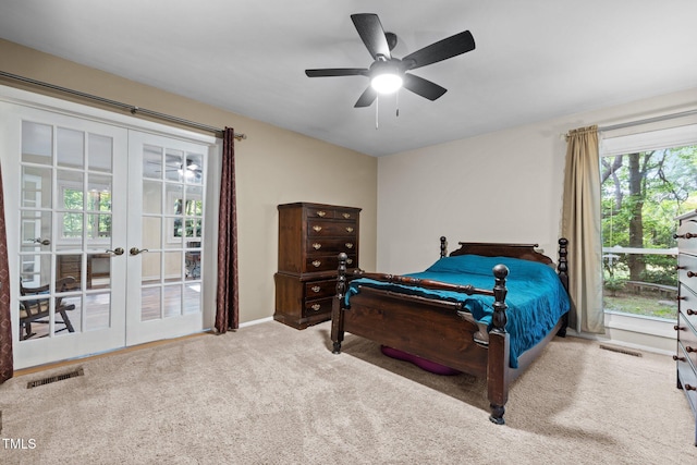 carpeted bedroom with french doors, ceiling fan, and baseboards