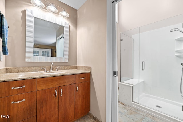 full bath with a shower stall and vanity