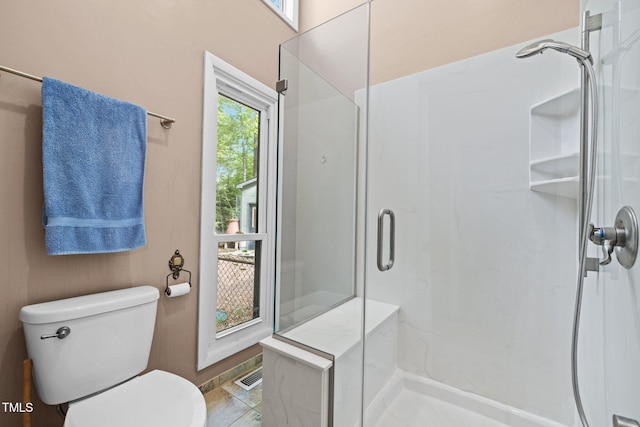 full bath with a shower stall, healthy amount of natural light, and toilet