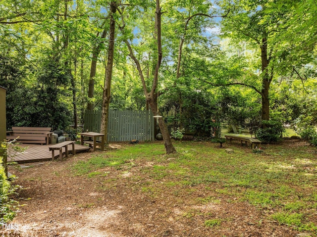 view of yard featuring fence and a deck