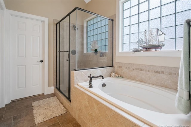 full bath with a shower stall and a bath
