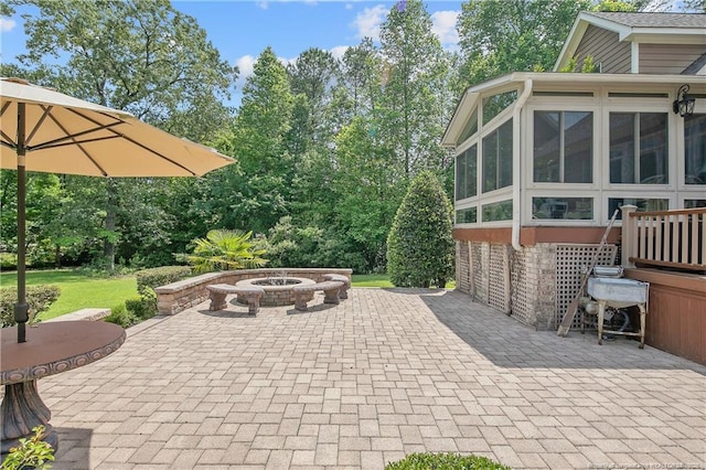 view of patio with a fire pit and a sunroom