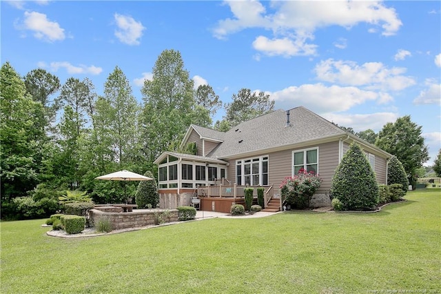 back of property featuring a sunroom, a wooden deck, and a yard