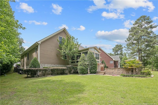 view of side of property with a lawn