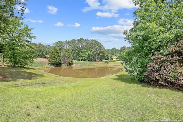 surrounding community featuring a water view and a yard