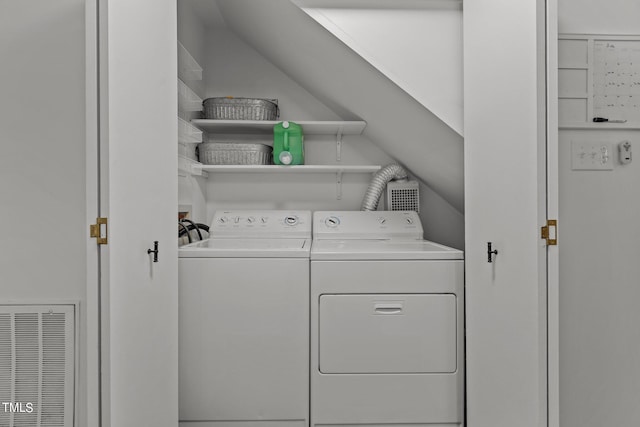 clothes washing area with washing machine and dryer