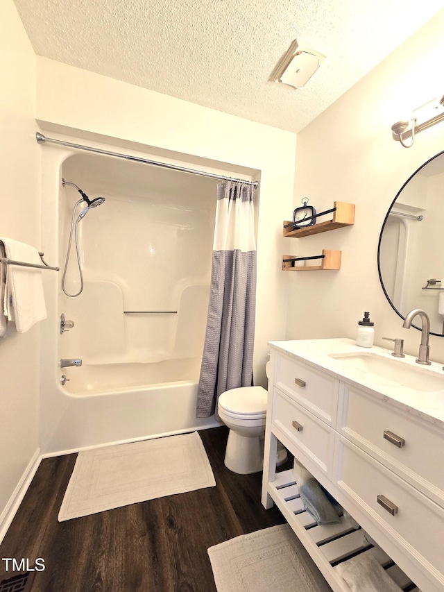 bathroom with wood finished floors, toilet, a textured ceiling, vanity, and shower / bathtub combination with curtain