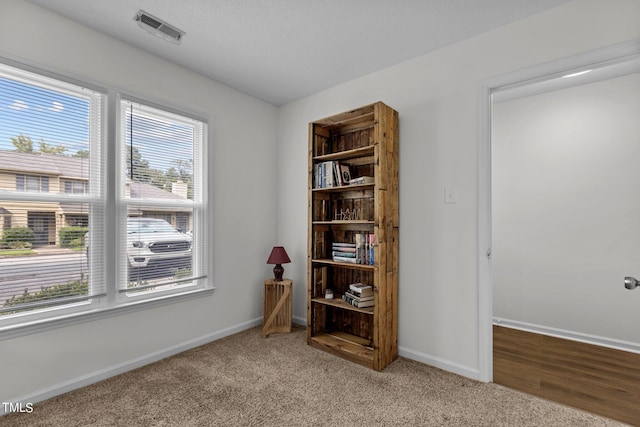 empty room with light colored carpet and baseboards
