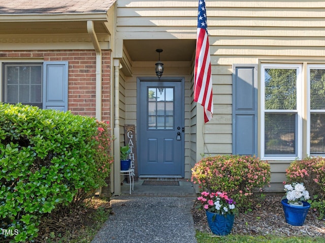 property entrance featuring brick siding