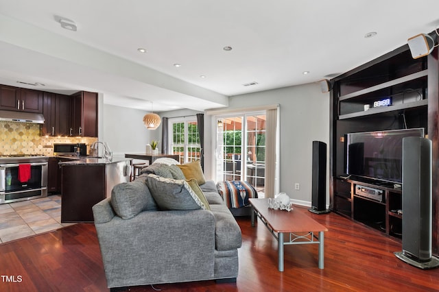 living room featuring dark wood-type flooring and recessed lighting
