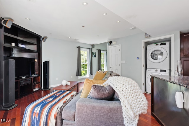 bedroom with stacked washer and clothes dryer, dark wood-style floors, and recessed lighting