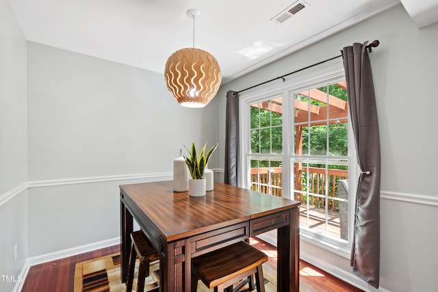 dining area with wood finished floors and baseboards