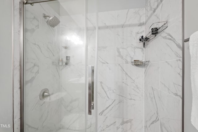 bathroom with a marble finish shower