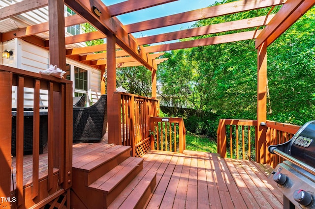 wooden deck featuring area for grilling and a pergola