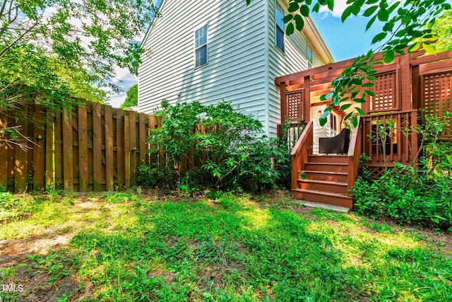 view of yard with fence and a deck