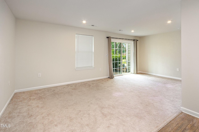 empty room with baseboards, carpet, and recessed lighting