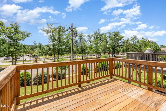 wooden deck featuring view of scattered trees